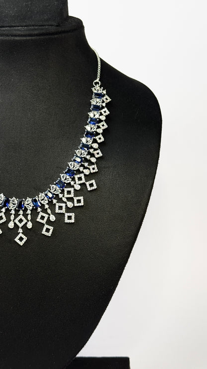 Elegant necklace with blue and silver stones on a black mannequin against a white background